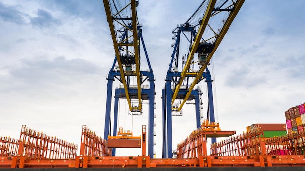 Maritime port with stacked containers and cranes used in drayage operations in Japan