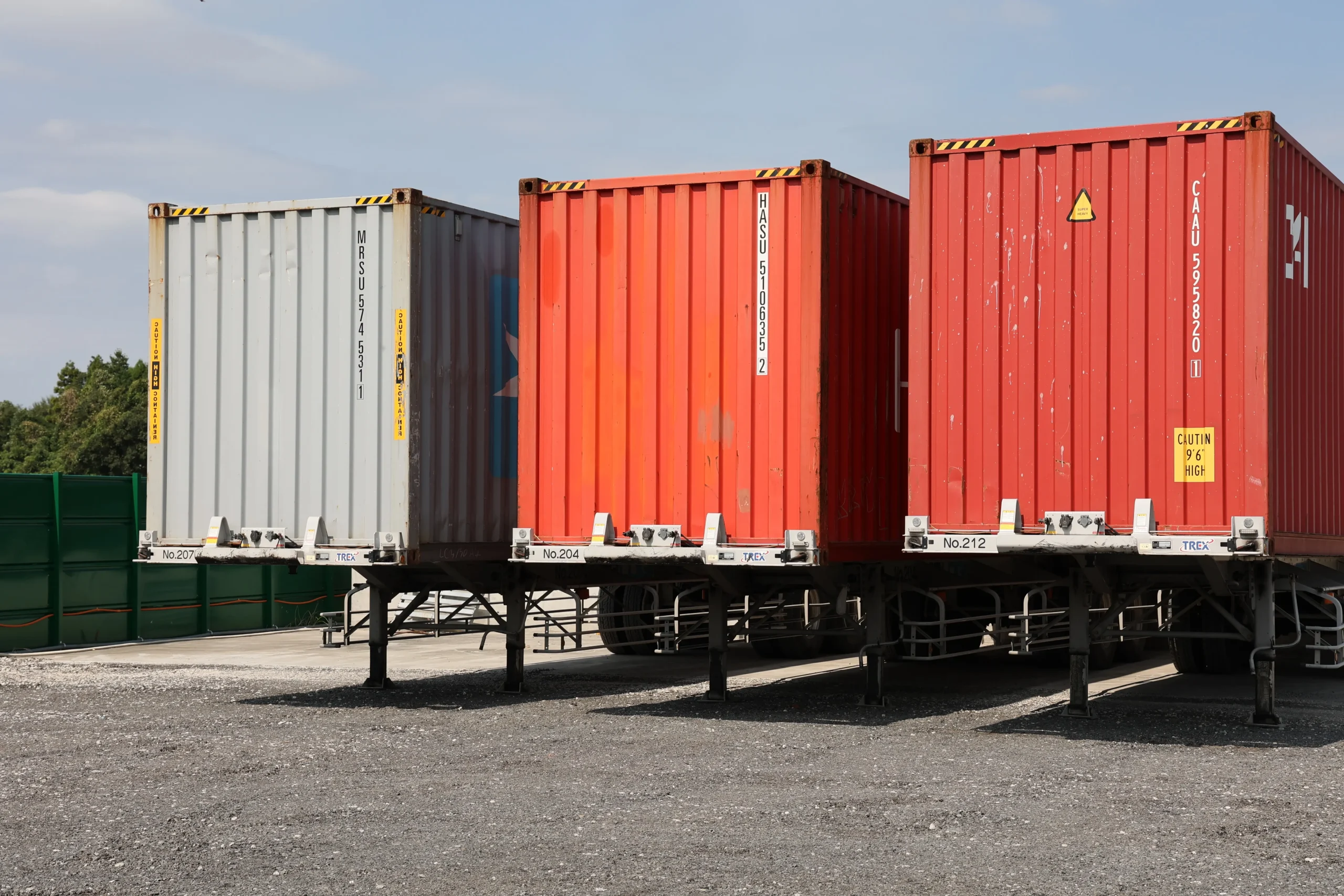 Shipping containers at a logistics yard representing reliable freight forwarding services in Japan.